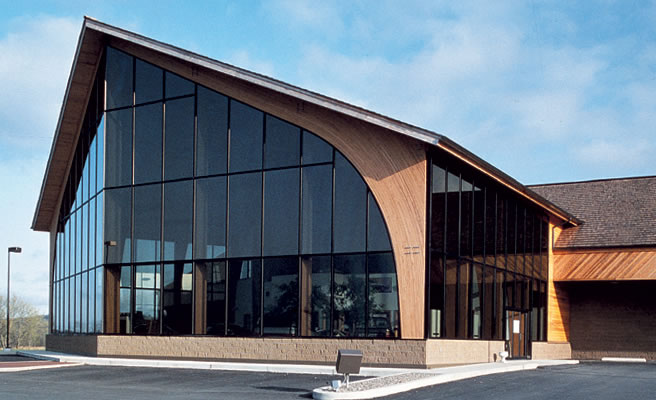 Glass fronted building with laminated beam supports.