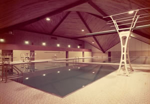 Custom natatorium with indoor pool with wooden glulam ceiling.