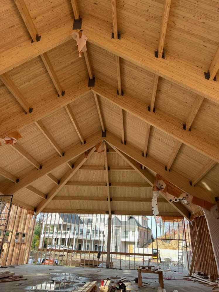 Wooden indoor tennis pavilion roof from below