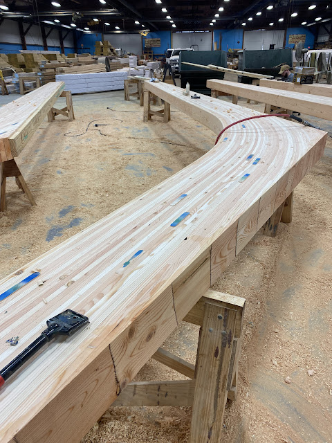 A laminated wood beam in the process of being finished.