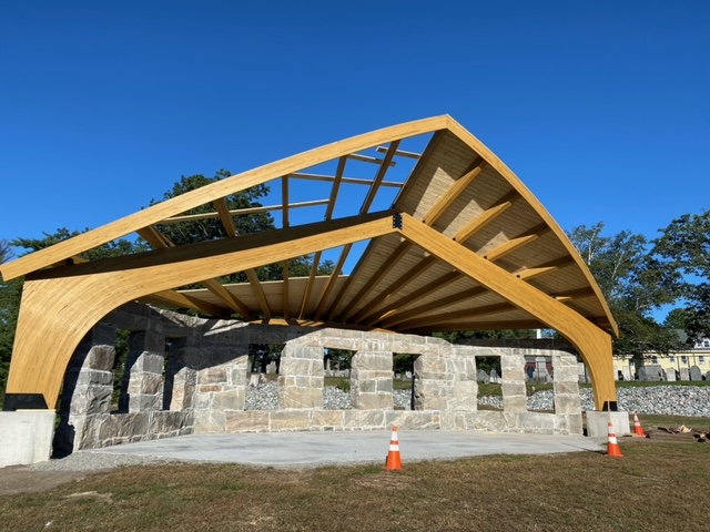 Curved wood laminate construction beam in a partially built structure by Unalam.