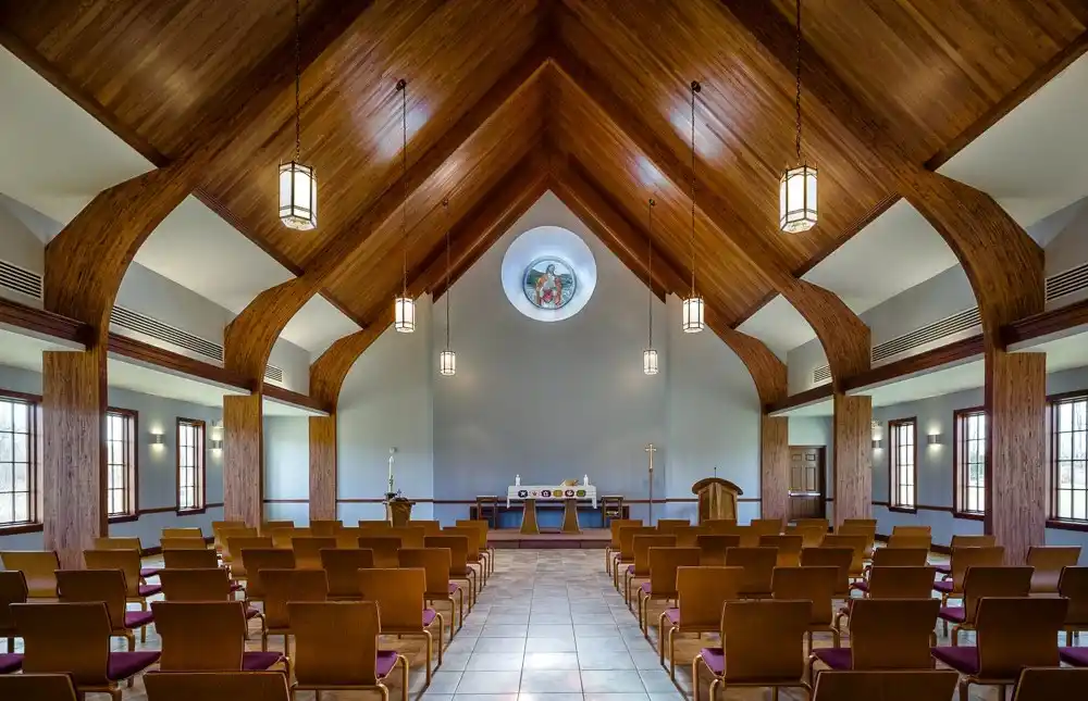 Interior of a chapel featuring Unalam wood laminate beams and seating.