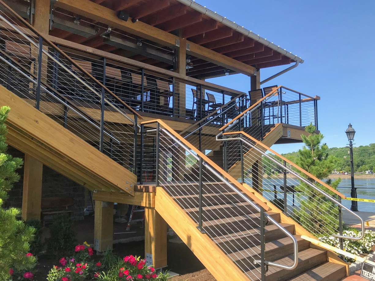 Stairs and deck built with Unalam wood laminate beams near a lake.