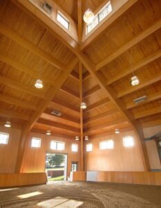Interior view showcasing Unalam's wood laminate construction beams and lighting.