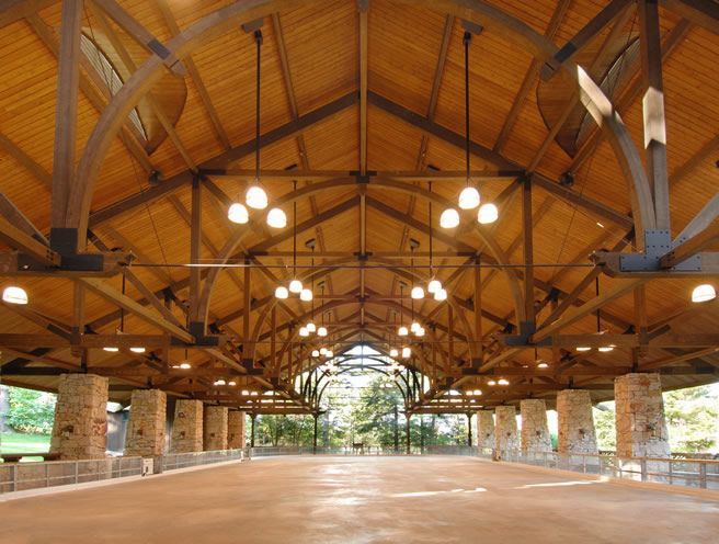 Interior of a spacious building featuring wood laminate construction beams.